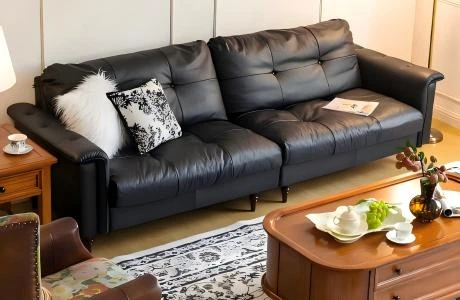 Cohesive interior design featuring a black leather sofa, brown armchair, and classic rug, highlighting George Homes' one-stop building project solutions.
