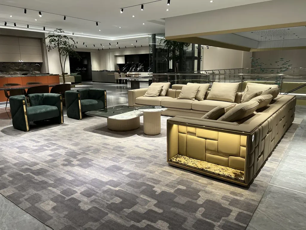 Modern luxury living room furniture layout featuring custom sectional sofas, velvet armchairs, and a marble coffee table at George Homes Foshan showroom.