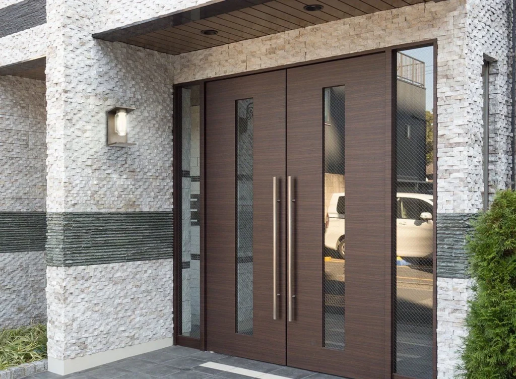 Modern double solid wood entry doors featuring long vertical glass panels and sleek metallic hardware for contemporary projects.