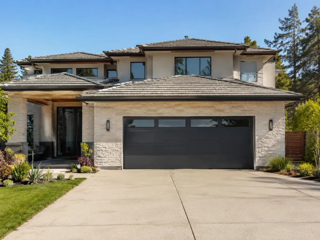 Luxury home exterior featuring a standard double garage door size with top panel windows.